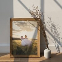 Dried white statice flower in a white vase by a wooden frame  mockup on a wooden floor